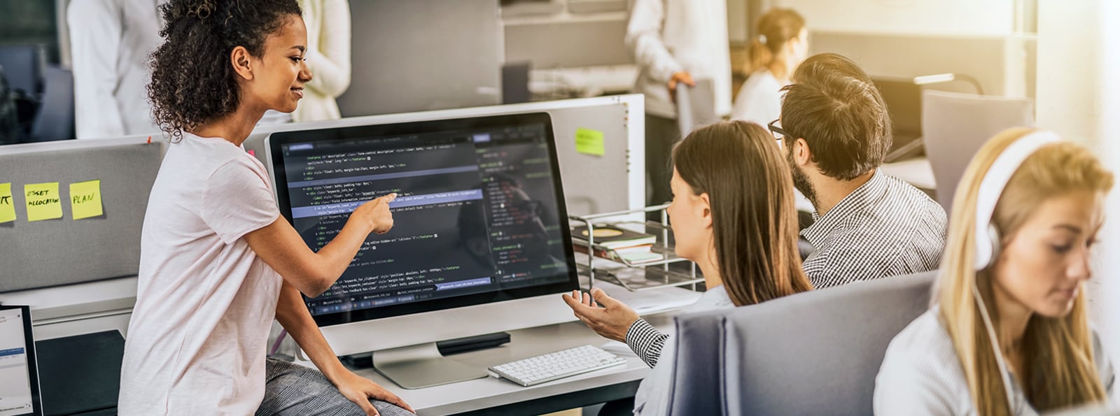 Agile Software Development team in office on computer banner image